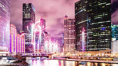 Fireworks display celebration along the Chicago River at Wolf Point in Chicago, Illinois. Time lapse