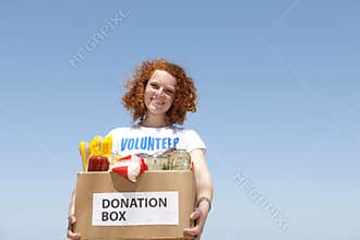 Volunteer carrying food donation box