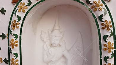 Asian angel sculpture art around the base of pagoda