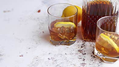Whiskey sour drink with lemon in glass on stone rustical background