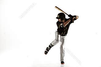 Baseball player, pitcher in a black uniform practicing on a white background.