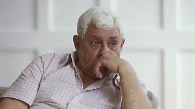 Sad senior grey haired man crying sit alone at home