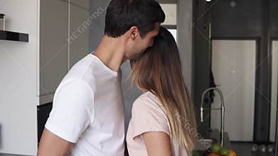 Sensual slowmotion footage of affectionate man in white T shirt caressing his young girlfriend with passion. Long haired