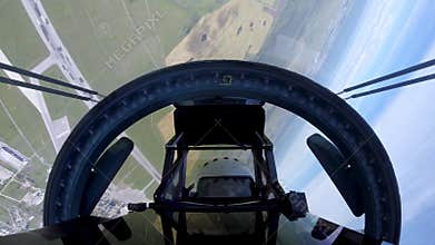 Su-35 aircraft with a pilot spinning in air above field and performing maneuvers