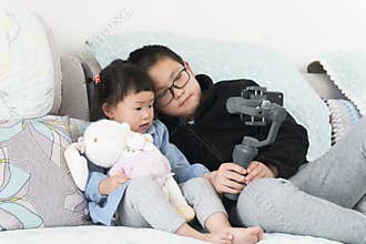 Chinese kids selfie with gimbal at home