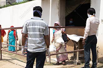 People in masks serving food to underprivileged people like maids, drivers, house cleaners etc during the coronavirus