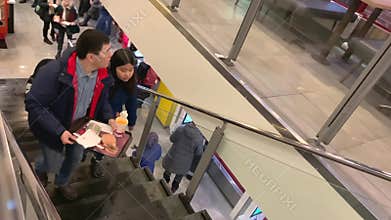 A young couple of Asians in McDonald`s.