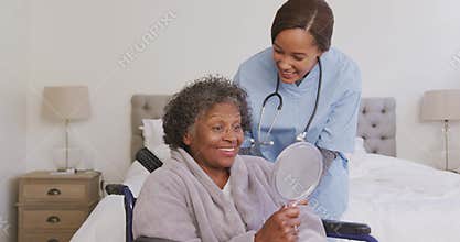 Mixed race woman being visited at home by a nurse. Social distancing and self isolation in quarantin