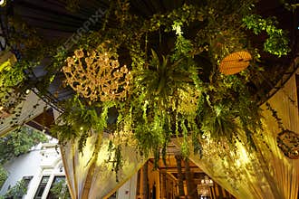 Floral decoration hanging from ceiling at wedding venue