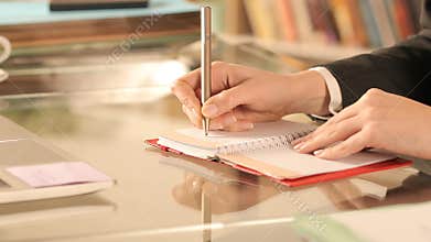 Entrepreneur hand taking notes on agenda at homeoffice