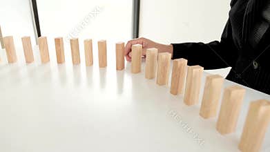 Business women use hand to pick up wooden blocks to prevent other, Concept Risk of management and strategy plan