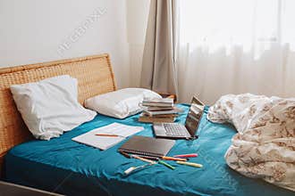 Home interior in bedroom with laptop and books for distant remote self education. Virtual class lesson on video online Internet