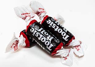 Tootsie Rolls on white background.