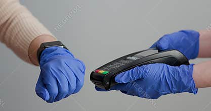 Making payment with smart watch and pos terminal. Customer paying with NFC technology by smart watch contactless on