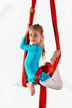 Pretty little girl in a blue gymnastic suit