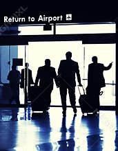 Business travelers exiting Airport terminal.