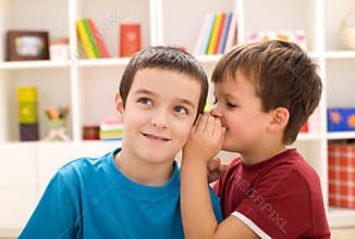 Two boys sharing a secret