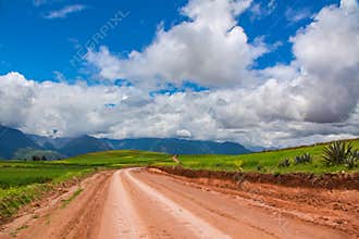 Beautiful landscape of gravel road, fields, meadows and mountains in Peru, South America
