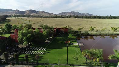 Charro wedding bride and groom with horse walking in a lake hacienda venue