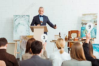 Selective focus of auctioneer holding gavel