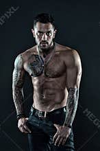 Be strong. muscular bodybuilder with body tattoo. athletic male show abdominal muscles. fitness model topless