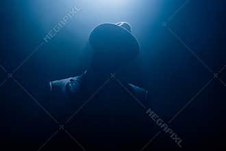 Silhouette of dangerous gangster in suit
