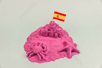 An island with Spain flag on a sand castle