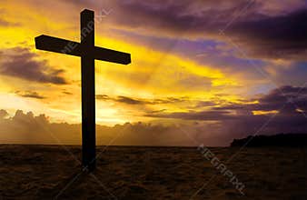 Christian cross on sunset