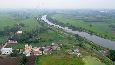 Aerial view of Kolakalur village surrounded with lush green paddy fields near Tenali town, Guntur district in India