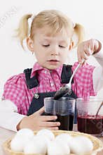 Girl during Easter eggs' coloration