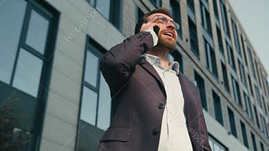 Anxious mad Caucasian man stressed male businessman employer arguing mobile phone conversation outdoors angry boss ceo