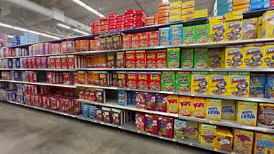 Panning left on the breakfast cereal aisle at a Walmart Store with no people