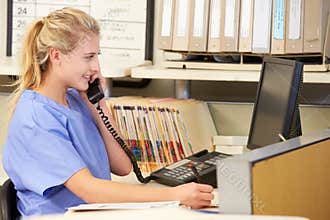 Nurse Making Phone Call At Nurses Station