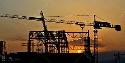 Silhouette crane building and sunset