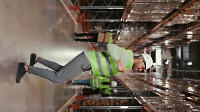 Vertical Video. African American Male Worker in Uniform Spontaneously Funny Dancing and Enjoying Himself with Ordered