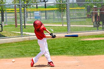 Young baseball player swinging bat