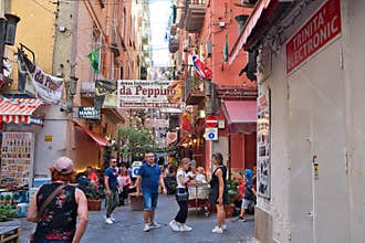 Busy street packed with people in the Guartieri Spagnoli neighborhood in Naples, Italy