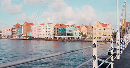 Queen Emma Bridge in and colorful Unesco buildings during sunset, Curacao