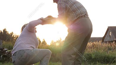 Elderly Man Gives Helping Hand To Woman Has Fallen To Ground And Helps To Get Up