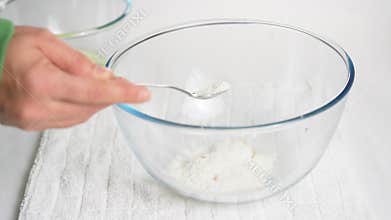 Pour a teaspoon of baking powder into a transparent bowl with eggs to prepare the dough.