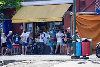 Group of tourists on the street near &#x22;salumeria da Aldo&#x22; market in summertime, Capri Island, Naples