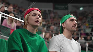 Tense fans wait goal outcome at sport stadium. Anxious people worry winning bet.