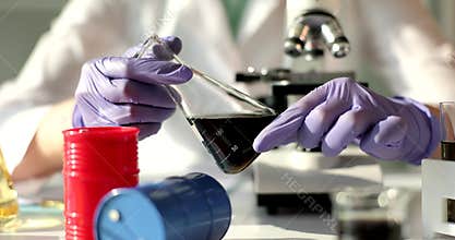 Crude oil in vial vial in laboratory assistant hand