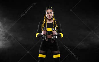 African american woman athlete. Download photo for fitness club advertising design. Woman workout with dumbbells in gym.