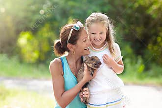 Kids and farm animals. Child with baby pig at zoo