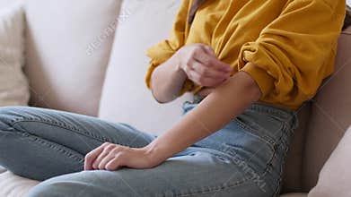 Allergy attack. Unrecognizable woman scratching her hand, suffering from allergic reaction or mosquito bite, empty space
