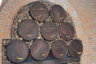 tacked Wooden Barrels in Brick Cellar with Firewood