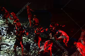 Theatrical Water Performance with Dancers Under Red Lighting