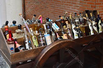 Assorted Liquor Bottles Displayed on Rustic Wooden Cart