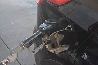 Pumping gas into a suv
